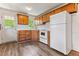 Charming kitchen with wood-look flooring, white appliances, and wooden cabinets at 1543 Wickham St, Burlington, NC 27215