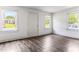 Well-lit living room with wood-look flooring and multiple windows at 1543 Wickham St, Burlington, NC 27215