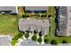 An aerial view shows townhouse exteriors with private driveways and manicured green lawns in a well-planned community at 16 Daly Ct, Durham, NC 27705
