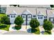 An aerial view of townhomes with well-manicured lawns and mature trees lining the driveways at 16 Daly Ct, Durham, NC 27705