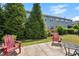 Landscaped backyard featuring a patio with outdoor seating, and evergreen trees for privacy at 16 Daly Ct, Durham, NC 27705