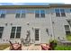 Back of home features outdoor seating on the patio, along with privacy and evergreen trees at 16 Daly Ct, Durham, NC 27705