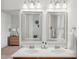 Double sinks and dual mirrors highlight this bathroom with a neutral color scheme at 16 Daly Ct, Durham, NC 27705