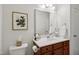 Well-lit bathroom featuring a large mirror and vanity at 16 Daly Ct, Durham, NC 27705