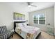Cozy bedroom with a plush bed, accent chair, ceiling fan, and a bright window with natural light at 16 Daly Ct, Durham, NC 27705