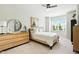 Light and airy bedroom featuring a wood frame bed, ample natural light, and modern furnishings at 16 Daly Ct, Durham, NC 27705