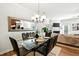 This dining area features a glass table with leather chairs and a decorative mirror and chandelier at 16 Daly Ct, Durham, NC 27705