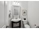 Neat half bathroom with a pedestal sink, framed mirror, and a decorative towel rack at 16 Daly Ct, Durham, NC 27705