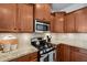 Well-lit kitchen features granite countertops and stainless steel appliances at 16 Daly Ct, Durham, NC 27705
