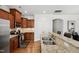 Well-equipped kitchen featuring stainless steel appliances, granite countertops, and wood cabinets at 16 Daly Ct, Durham, NC 27705