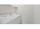 The laundry room includes a washer, dryer, and shelving for storage at 16 Daly Ct, Durham, NC 27705