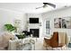 Bright living room featuring a fireplace, ceiling fan, and a stylish blend of furniture and decor at 16 Daly Ct, Durham, NC 27705