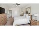 Cozy main bedroom with a ceiling fan, modern furniture and bright neutral colors at 16 Daly Ct, Durham, NC 27705