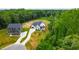 Aerial view of newly constructed home with lush green landscaping, a long driveway and black trim at 164 E Spring Showers Trail Trl, Angier, NC 27501