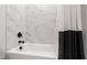 Bathroom featuring a modern tub with marble tiled backsplash and a black and white shower curtain at 164 E Spring Showers Trail Trl, Angier, NC 27501