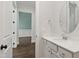 Clean and simple half bathroom featuring white vanity, round mirror, and neutral walls at 164 E Spring Showers Trail Trl, Angier, NC 27501