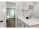 Bathroom vanity featuring white cabinets, a large mirror and a view into a bedroom at 164 E Spring Showers Trail Trl, Angier, NC 27501