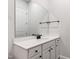 Bathroom vanity featuring white countertop, dark hardware, and a large mirror at 164 E Spring Showers Trail Trl, Angier, NC 27501