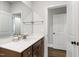 Bathroom vanity with wood cabinets, silver hardware and a large mirror at 164 E Spring Showers Trail Trl, Angier, NC 27501