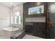 A bathroom features a glass shower enclosure with a rain head fixture and a soaking tub with a modern faucet at 164 E Spring Showers Trail Trl, Angier, NC 27501
