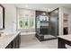 A modern bathroom features a soaking tub, a glass enclosed shower with rain head, and a dual sink vanity with storage at 164 E Spring Showers Trail Trl, Angier, NC 27501