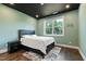 Bedroom featuring a queen bed, hardwood floors, and light green walls at 164 E Spring Showers Trail Trl, Angier, NC 27501