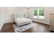 Bright bedroom with a large window, hardwood floors, and a tufted headboard at 164 E Spring Showers Trail Trl, Angier, NC 27501