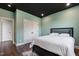 Bedroom featuring a queen bed, hardwood floors, and a closet at 164 E Spring Showers Trail Trl, Angier, NC 27501