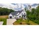 Aerial view of a two-story home with a well-manicured lawn and professional landscaping at 164 E Spring Showers Trail Trl, Angier, NC 27501