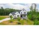 Beautiful two-story home with a gray roof, white siding, and stone accents at 164 E Spring Showers Trail Trl, Angier, NC 27501