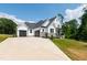 Stunning white two-story house with large driveway and attached two-car garage at 164 E Spring Showers Trail Trl, Angier, NC 27501