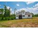 Exterior of a two-story home with white siding and a covered porch, nestled in a wooded area at 164 E Spring Showers Trail Trl, Angier, NC 27501