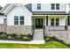 Charming front porch with stone details, black railings, and a double door entry at 164 E Spring Showers Trail Trl, Angier, NC 27501