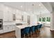 Bright, white eat-in kitchen with stainless steel appliances, large island, and modern lighting at 164 E Spring Showers Trail Trl, Angier, NC 27501
