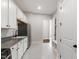 Laundry/mud room featuring ample white cabinets, granite counters, and stainless appliances at 164 E Spring Showers Trail Trl, Angier, NC 27501