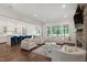 The open-concept living room flows seamlessly into the kitchen, featuring hardwood floors, a stone fireplace, and natural light at 164 E Spring Showers Trail Trl, Angier, NC 27501