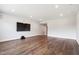 Open living room with hardwood floors, recessed lighting, and a large mounted TV at 164 E Spring Showers Trail Trl, Angier, NC 27501