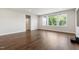 Spacious living room with hardwood floors, a large window, and natural light at 164 E Spring Showers Trail Trl, Angier, NC 27501