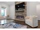 Inviting living room features a stone fireplace, modern electric fireplace and hardwood floors at 164 E Spring Showers Trail Trl, Angier, NC 27501