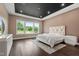 A well-lit main bedroom features a dark ceiling, recessed lighting, and a large window offering natural light and views at 164 E Spring Showers Trail Trl, Angier, NC 27501