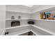 Walk-in pantry featuring organized shelving with a variety of storage options and a skylight at 164 E Spring Showers Trail Trl, Angier, NC 27501