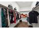 This large walk-in closet includes custom shelving and racks for ample storage with bags and a full wardrobe visible at 164 E Spring Showers Trail Trl, Angier, NC 27501