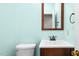 Cozy bathroom featuring a wood-framed mirror, modern sink, and soft blue walls at 18 Frances St, Chapel Hill, NC 27517