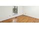 Hardwood floors flow through this simple bedroom with bright window at 18 Frances St, Chapel Hill, NC 27517