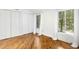 Bright bedroom with hardwood floors, white walls, and large windows with blinds at 18 Frances St, Chapel Hill, NC 27517