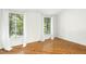 Sunlit bedroom with hardwood floors and view of surrounding trees from large windows at 18 Frances St, Chapel Hill, NC 27517