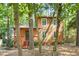 Charming two-story home with wood siding, front porch, and nestled among mature trees at 18 Frances St, Chapel Hill, NC 27517