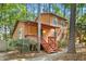 Two story home through the trees with front porch and multi-paned windows, wood exterior at 18 Frances St, Chapel Hill, NC 27517