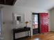Foyer features a bright red front door, hardwood floors and a decorative table with a mirror at 18 Frances St, Chapel Hill, NC 27517