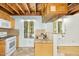 Bright eat-in kitchen features a tile backsplash, granite countertops, and wood beam ceilings at 18 Frances St, Chapel Hill, NC 27517